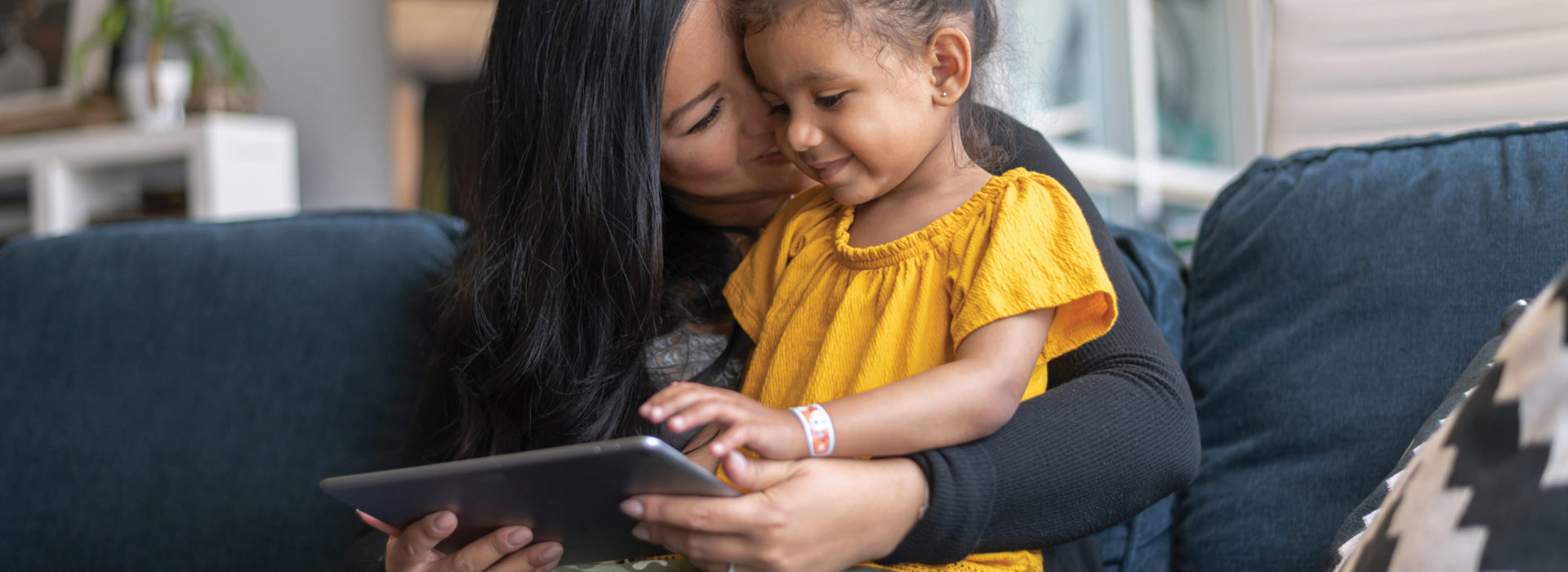 mom and child looking at a tablet