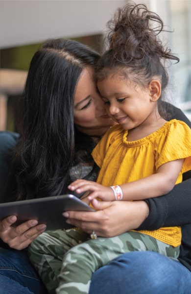 mom and child looking at a tablet